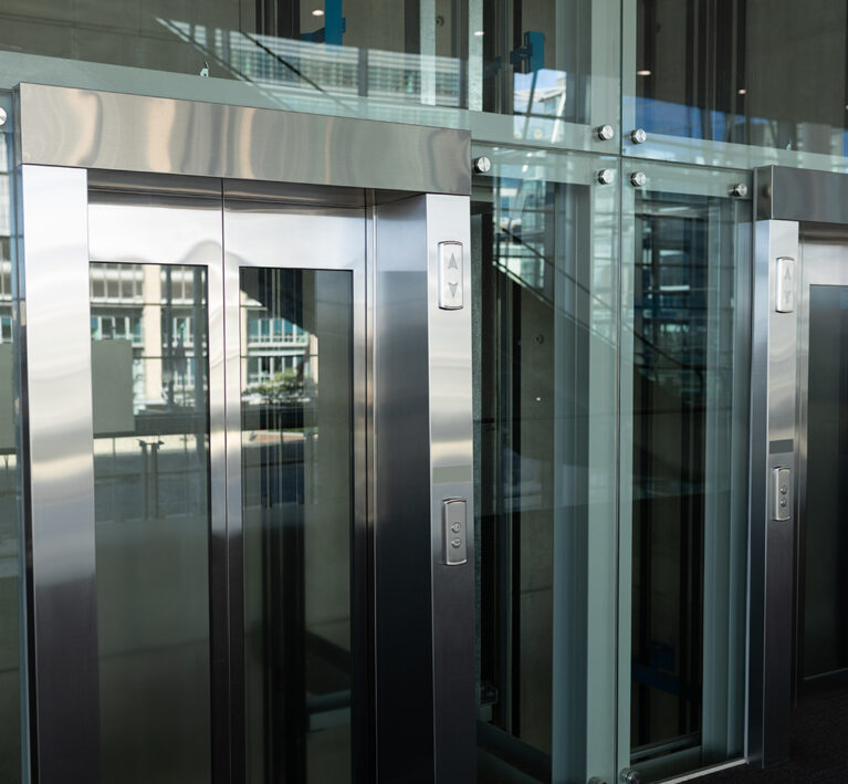 Side view of two modern elevators in a workplace