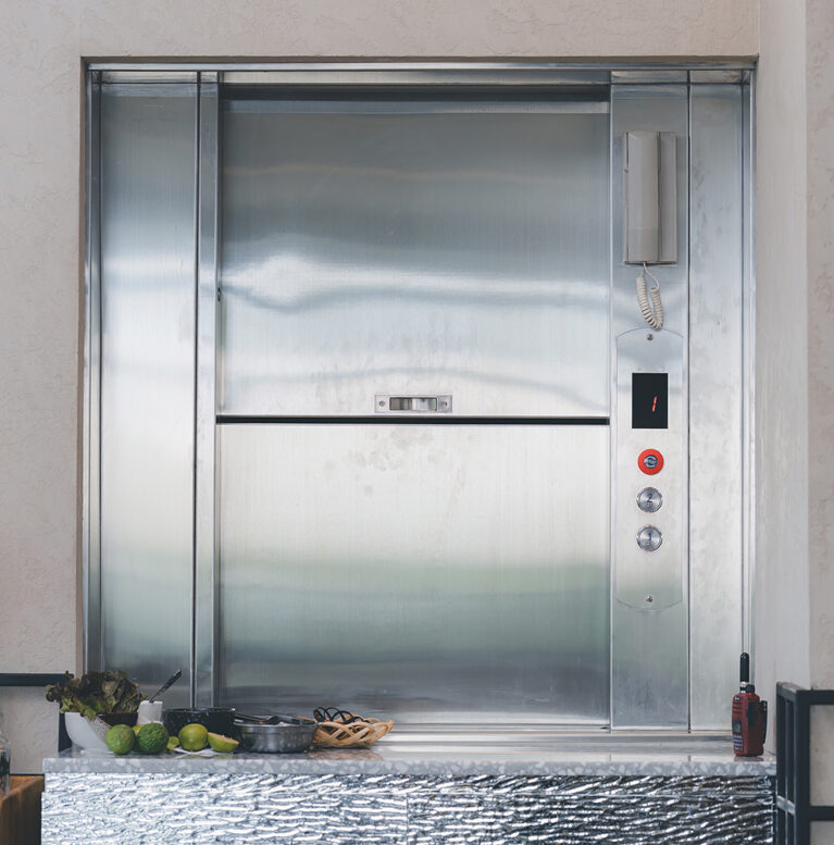 Dumbwaiter Lift elevator in a kitchen of Restaurant or Hotel used for carrying food or goods. Food hoist and food elevator for ready meals. Small Freight Elevators or Dumbwaiters Food Elevators