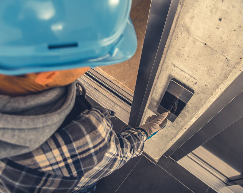 Professional Residential Elevator Technician Checking Call Button Operation. Scheduled Lifting Machine Warranty Maintenance.