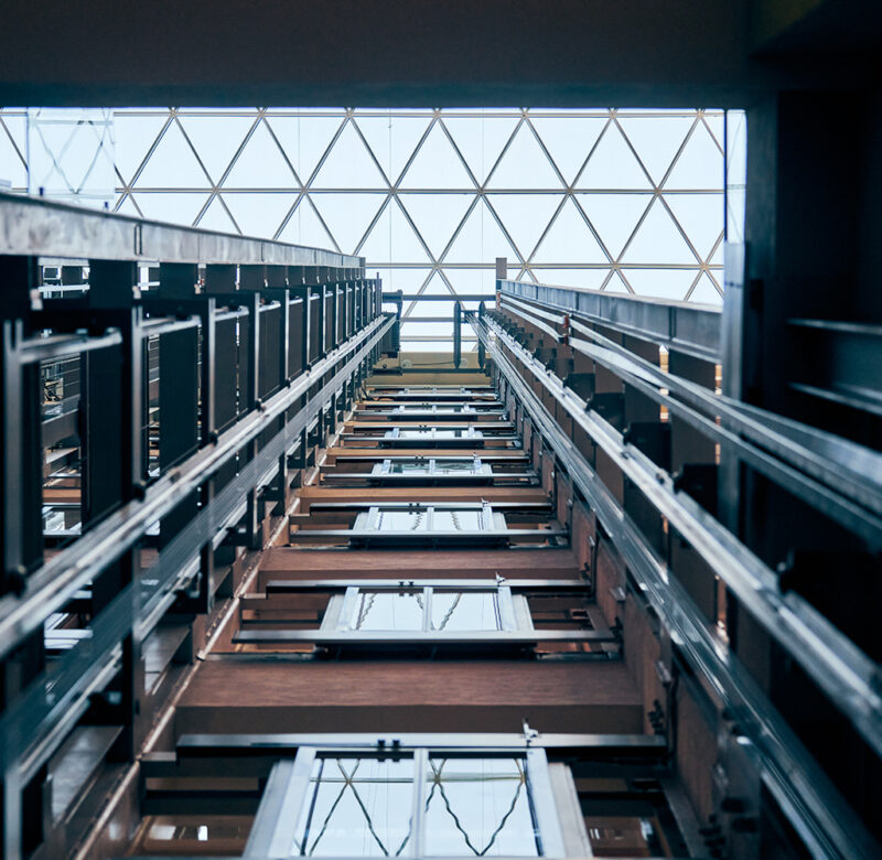 Open elevator lift shaft. Modern architecture with transparent ceiling. Shopping mall or business center. Maintenance repair and service
